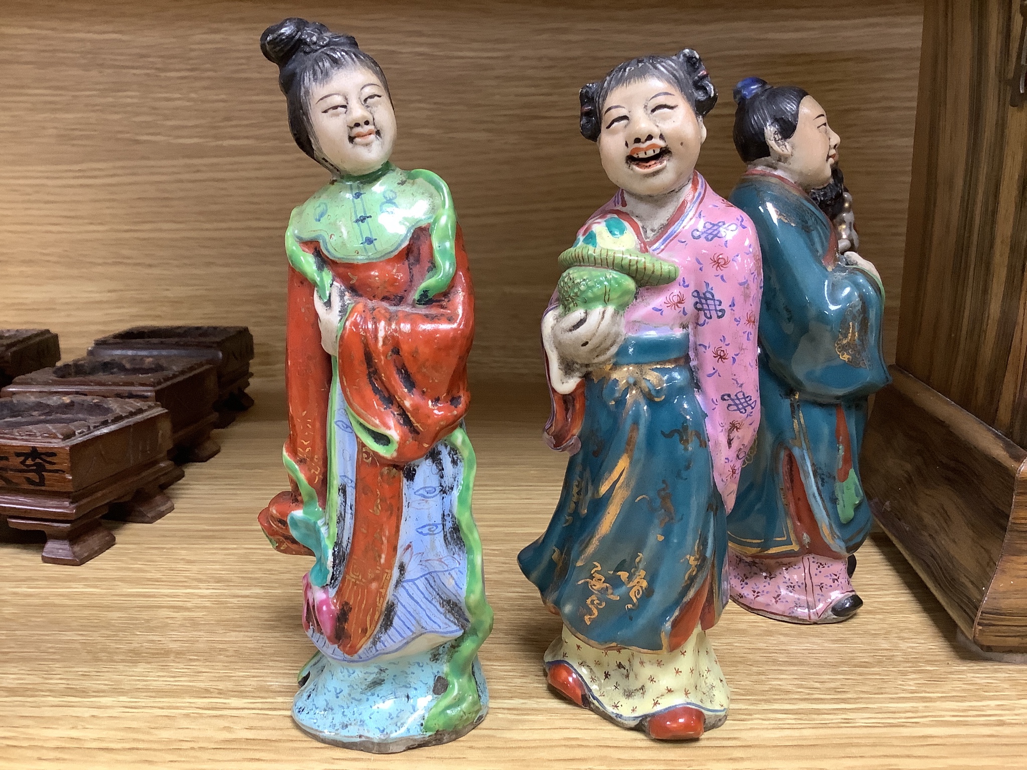 A set of eight 20th century Chinese porcelain figures of immortals, 15cm, each on carved wood stand